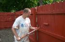 Mike Healey painting fence